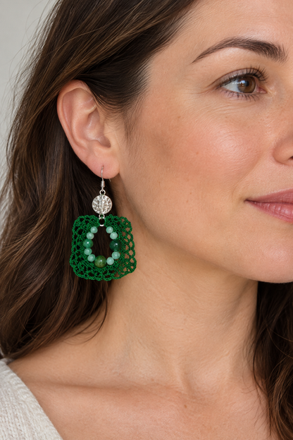 Visuel porté de boucles d’oreilles en coton vert foncé et perles d’émeraude, crochets argentés